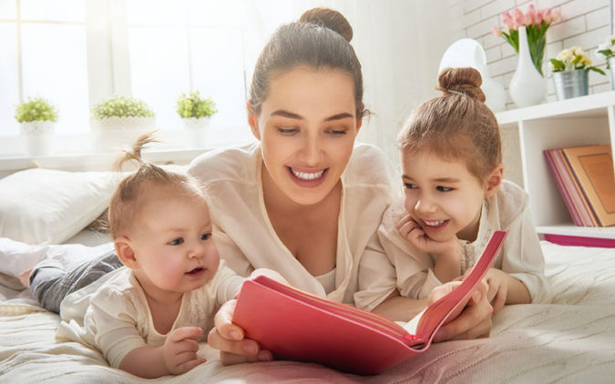 Mother Reading to Preschooler and Baby