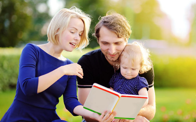 Mom and Dad Reading to Toddler