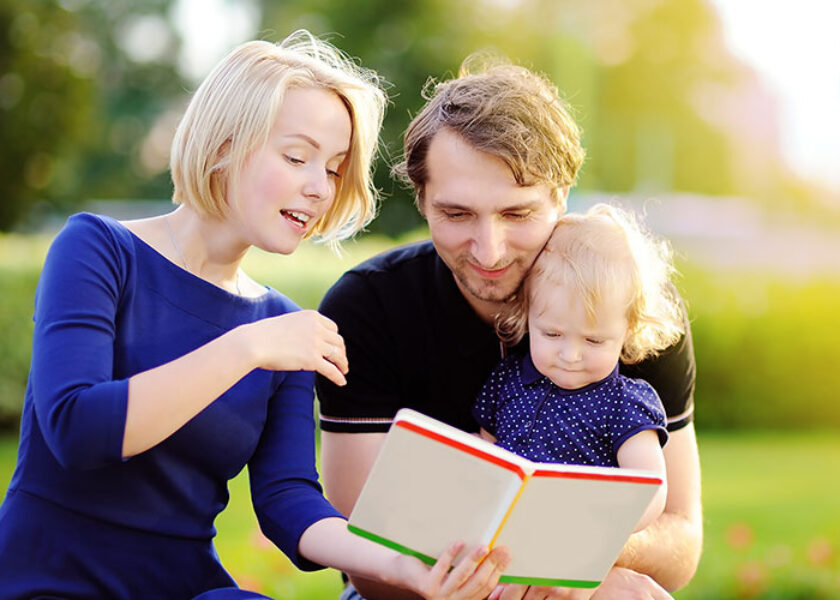 Mom and Dad Reading to Toddler