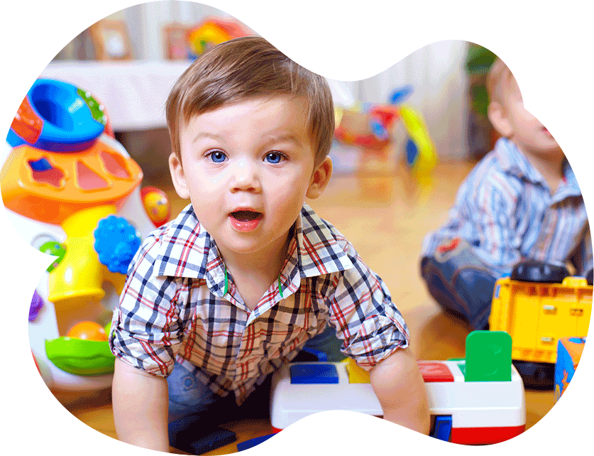 Toddler boy playing with colorful learning toys at Creative Corner Child Care Center